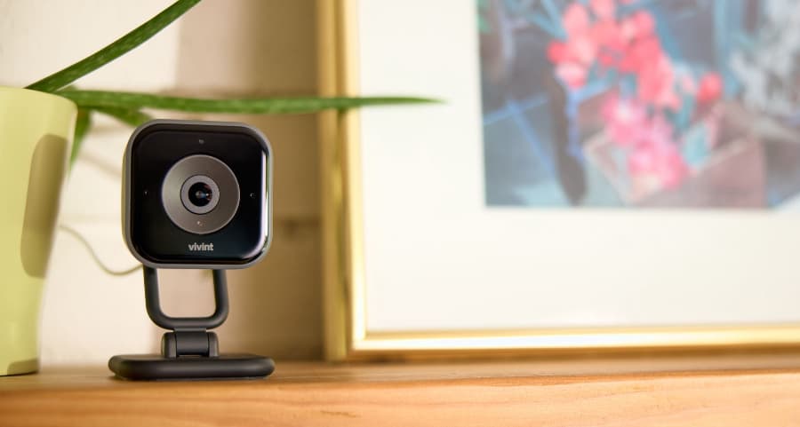 Vivint interior camera placed on a mantel near a picture